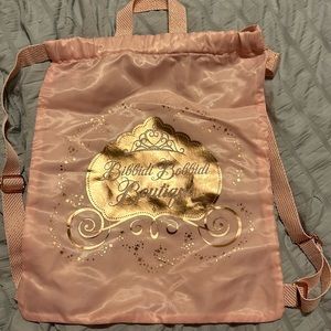 Disney Bibbidi Bobbidi Boutique pink and gold drawstring satin backpack.